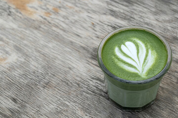 Matcha, green tea in glass cup. Grey stone background. Close up. Top view. Place for text.
