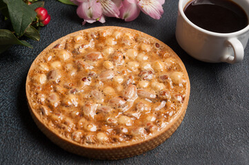 shortbread cake with nuts and caramel with a Cup of Americano