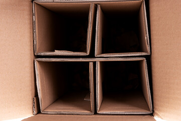 Closeup brown cardboard box with dividers. Glass bottle transport box
