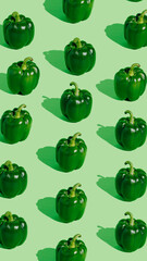 Pattern with fresh green bell peppers isolated on pastel green background. Creative organic vegetable concept. Banner for healthy food or diet. Pop art aesthetic texture.