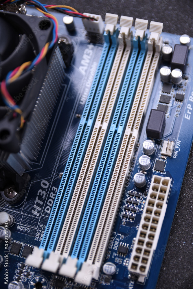 Poster computer fan on motherboard and electronical components cpu gpu memory and different sockets for vid