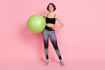 Full body photo of young sportive girl happy positive smile hold fitball activity isolated over pink color background