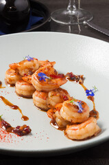 tiger prawns in sauce decorated with small flowers