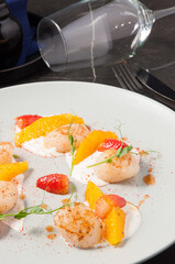 tasty fried scallops with strawberries and orange