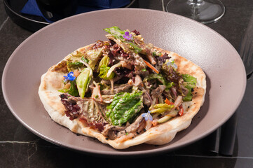warm salad with veal and vegetables on a wheat pit