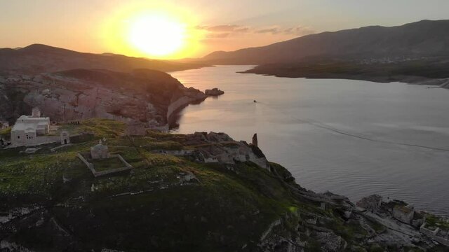 Eastern Turkey, Mesopotamia, the ancient city of Hasankeyf, caves in the rock. Aerial Drone Footage at sunset Time on the Coast of Tigres River