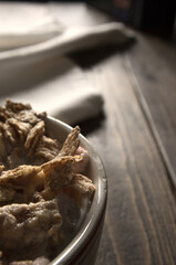 top view of a bowl of cereal on a rustic brown wooden table in vertical frame