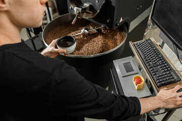 Fototapeta na wymiar Coffee processing. Roastery, roasting machine and fresh beans