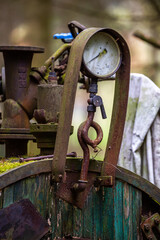 Pressure gauge on an illegal installation for the production of moonshine (alcohol). Photo taken in low light conditions.