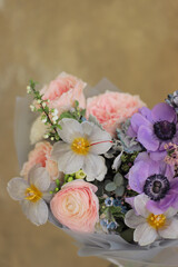 Delicate flower bouquet. Wrapped flowers bouquet. Fresh beautiful flower in hand.