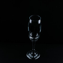 empty champagne flute on the black surface 