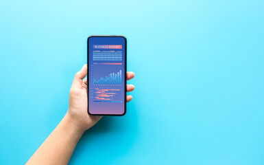 Business management with person hand showing smartphone and  information data on screen