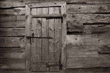 Mysterious old wooden door. Sepia photography.