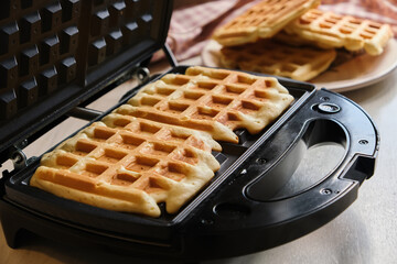 waffles are baked waffle iron machine. close up