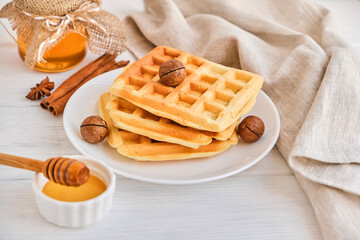 Stack of Belgian waffles on a white plate.