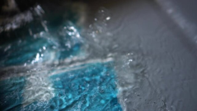 Cyanotype art printmaking with blue color washing and shaking water