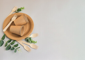 Fototapeta na wymiar Eco friendly craft paper tableware with monstera leaf. Zero waste theme.