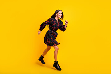 Fototapeta na wymiar Full length body size view of attractive cheerful girl jumping running motivation isolated over bright yellow color background