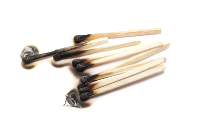 Burnt fire matches pile, used and burned matchsticks group isolated on white background
