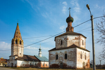 Naklejka premium Old Orthodox Holy Cross church in Suzdal in spring, Time-worn building with crumbling plaster, Part of Golden Ring ancient towns of Russia