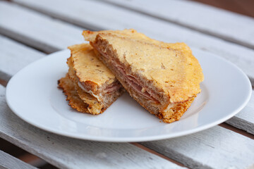Pan-toasted ham and cheese sandwich