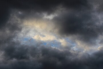 Clouds form in a dark cloud. Rays of sunlight