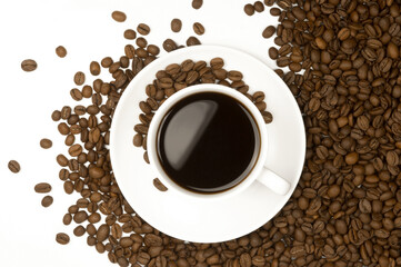 Cup of hot aromatic coffee with coffee grains isolated top view. Coffee background.