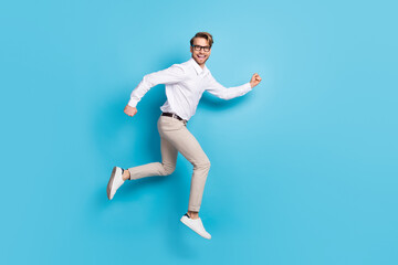 Fototapeta na wymiar Full length body size view of attractive cheerful glad man jumping running good mood isolated over bright blue color background