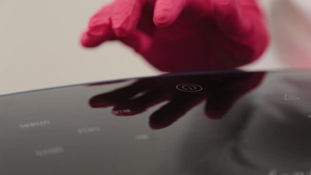 Woman beautician connects and adjusts the device for photo peeling.