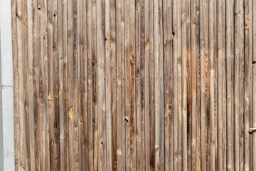 Fototapeta na wymiar Pattern of wooden fence in the sun with uneven wood