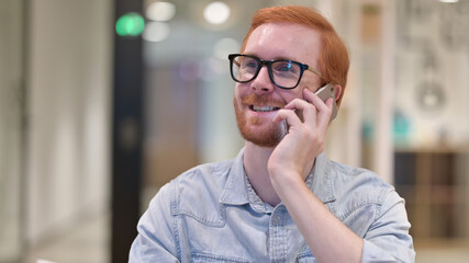 Young Redhead Man Talking on Phone 