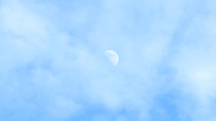 Moon and cloud on a blue sky.