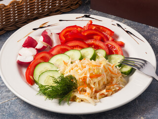 vegetable plate: cucumbers, tomatoes, bell peppers, cabbage, radishes