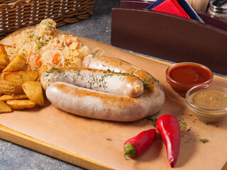 sausages with mushrooms, potato slices, cabbage and sauces