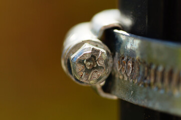 Macro image of the screw of a hose clamp