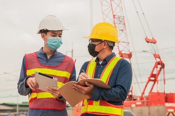 Engineer Worker Working teamwork on site construction , Man wear mask covid19