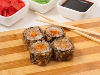 hot sushi rolls with shrimp on a wooden Board