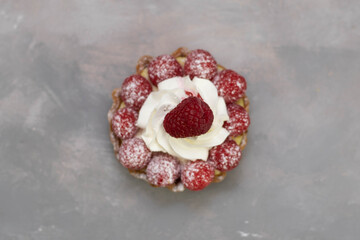 A delicious dessert for the whole family and easy diet, raspberry basket of unleavened dough with a gentle sprinkle with powdered sugar. Top view.