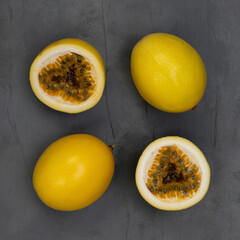 Yellow passion fruits on dark gray background. Top view