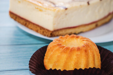 Fresh baked cupcake on wood background in close-up