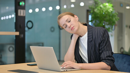 Tired Young Businesswoman with Laptop having Neck Pain 