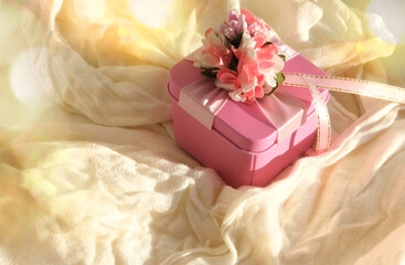 Blurred luxury pink gift box . Light and shadow. bedroom is decorated for holiday. Copy space Concept holiday. Happy Woman's Day, Mother's Day, Valentine's Day, Wedding