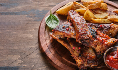 Spicy hot grilled spare ribs. Grilled and smoked ribs with barbeque sauce on a carving board.