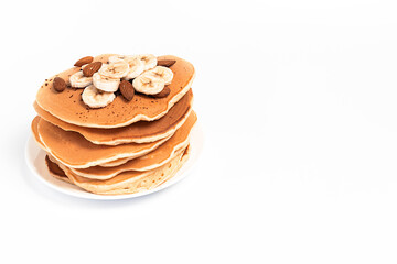 Pancake with bananas on a plate, on a white background, isolated, with a place for text