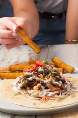 lunch with meat and vegetables on tortillas and French fries