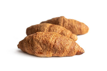 Several croissants made of puff pastry with a golden crust, on a white background