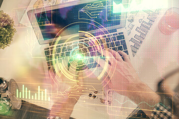 Multi exposure of man's hands typing over computer keyboard and data theme hologram drawing. Top view. Technology concept.