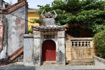 Hoi An, Vietnam, May 6, 2021: One of the side doors of the Ba Mu Temple gate in Hoi An