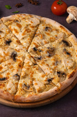 pizza with chicken and mushrooms on a wooden Board close-up