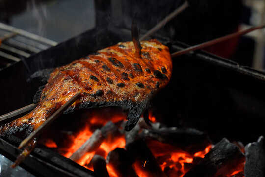 Masala fish been grilled on hot coals. Versova seafood festival, 2020, Mumbai, Maharashtra, India